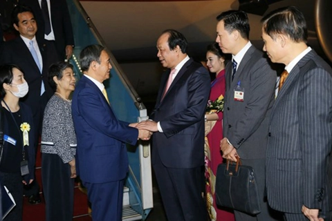 Suga arrives in Hanoi in first overseas trip as Japan PM