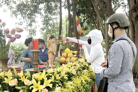 Buddhists perform ritual from distance on Vesak